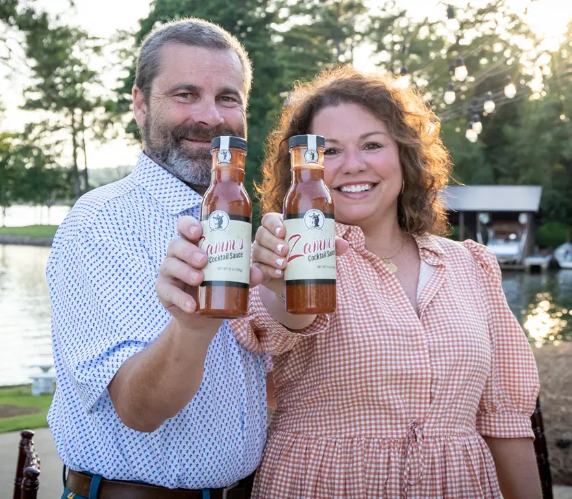 Kelly McKinstry & Husband holding Zamm's Cocktail Sauce Bottles